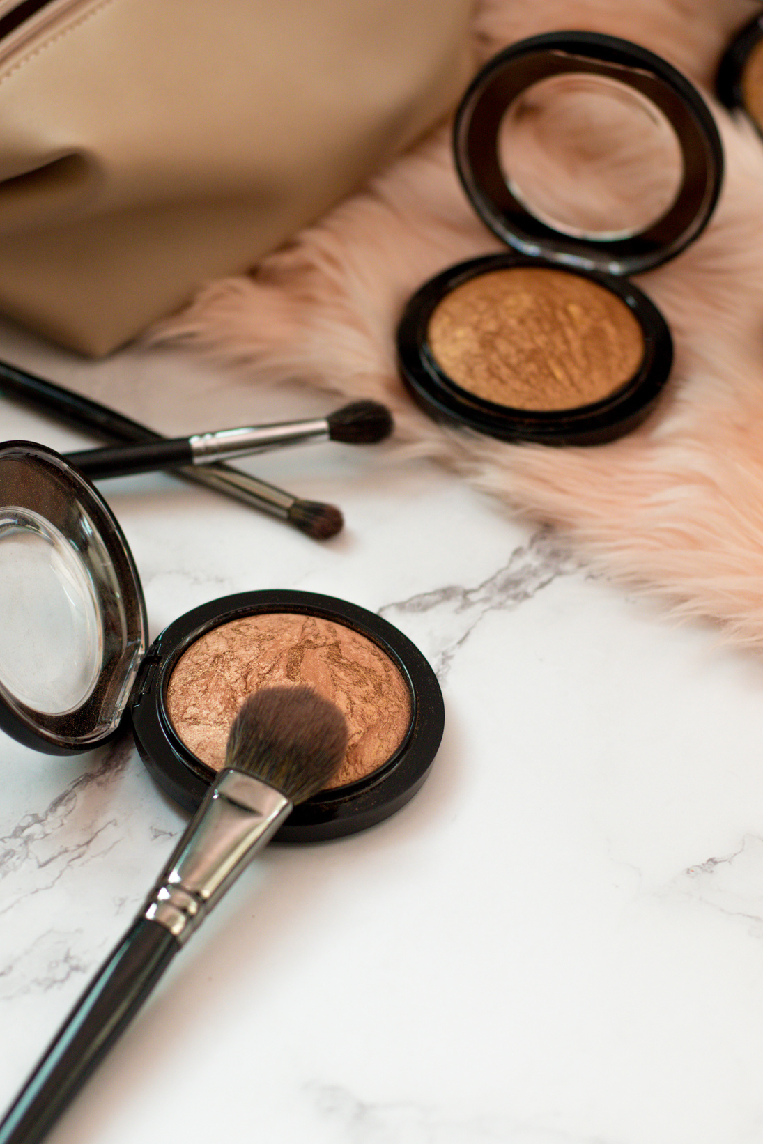 Blushes and Brushes on Table with Fur Carpet and Purse